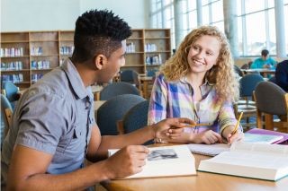 Friends talking in a library